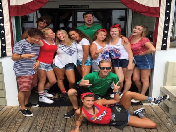 Staff of Shenanigan's dressed in red, white and blue and standing outside on the boardwalk.