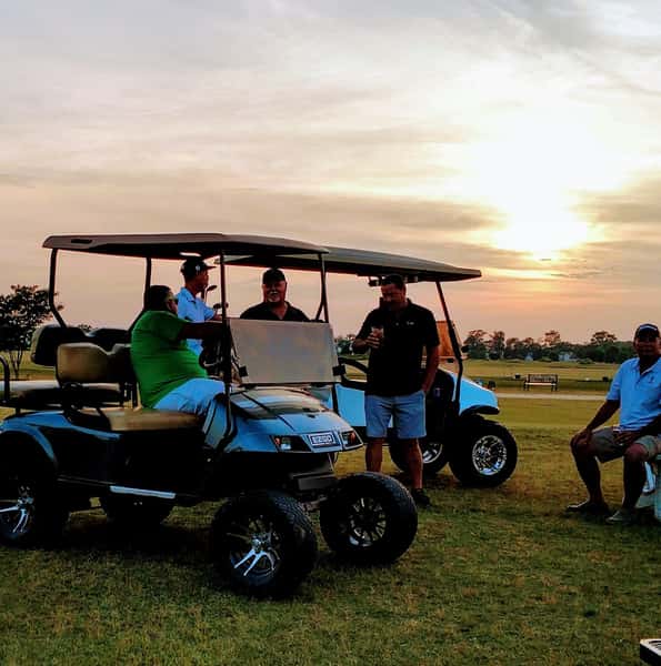 members on golf course at sunset