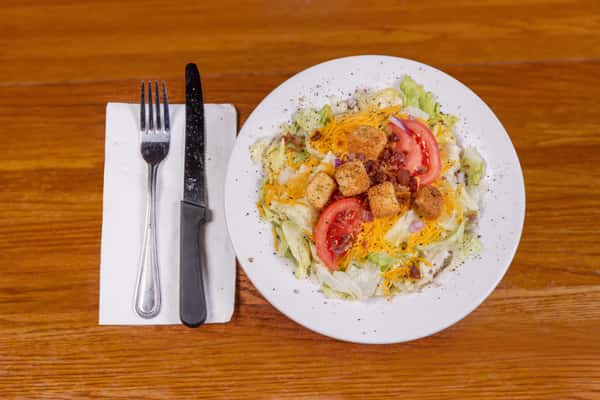 Garden side salad with lettuce, tomatoes, and shredded cheese at Jake & Rip's in Grenada, MS.