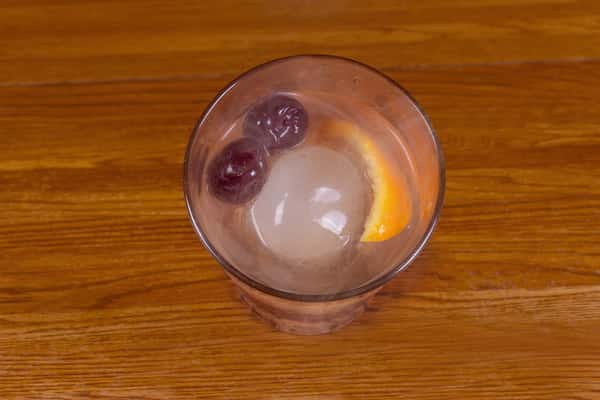 Smoked old fashioned cocktail with ice and cherry at Jake & Rip's bar in Grenada, Mississippi.