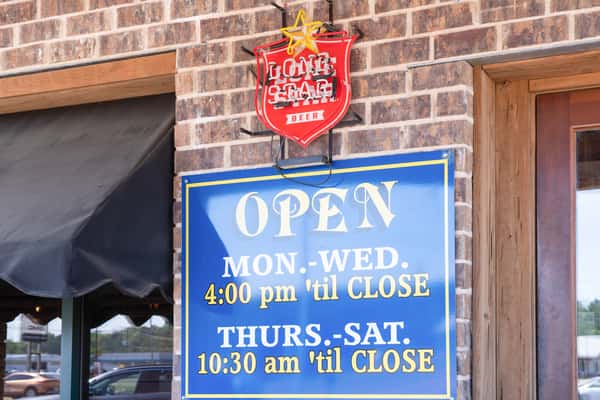 Open hours sign outside Jake & Rip's barbecue restaurant in Grenada, Mississippi.Open hours sign outside Jake & Rip's barbecue restaurant in Grenada, Mississippi.
