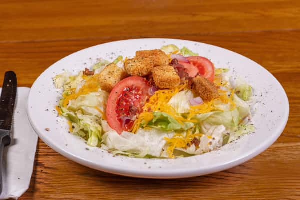 Garden side salad with lettuce, tomatoes, and shredded cheese at Jake & Rip's in Grenada, MS.