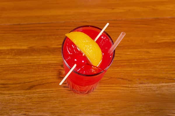 Overhead view of Jake & Rip's signature red cocktail with fruit garnish in Grenada, Mississippi.