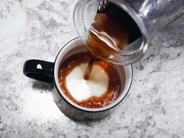pouring coffee into a mug