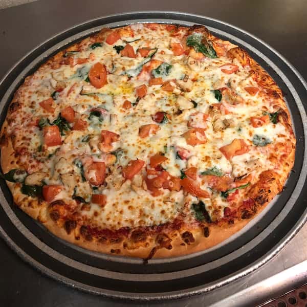 Pizza topped with diced tomatoes and Spinach