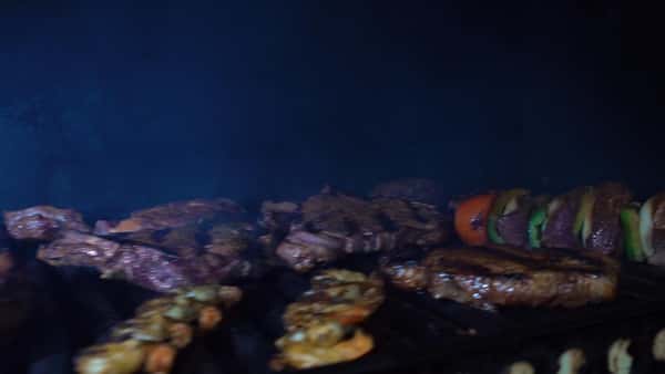 steaks on a grill with steak kabobs