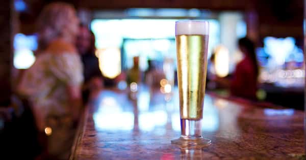 tall glass of beer on the bar counter