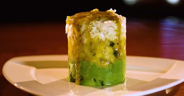 crab tower with avocado on a white plate