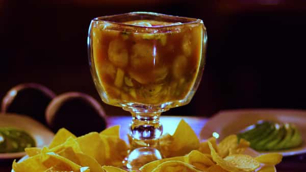 chilada in a glass bowl with chips on the side and avocados