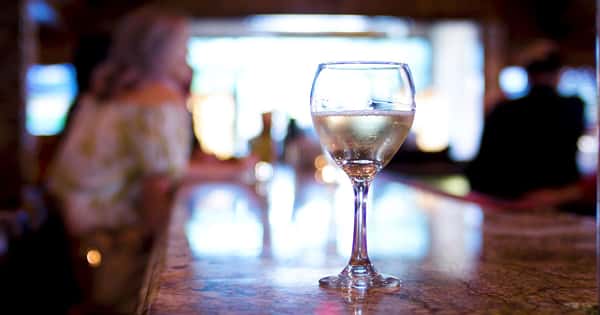 glass of white wine on the bar counter