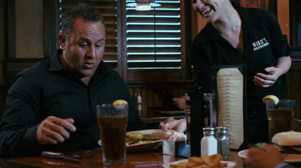 man getting a plate of steak from his waitress