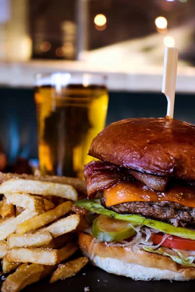 Freshly prepared burger with fries and beer