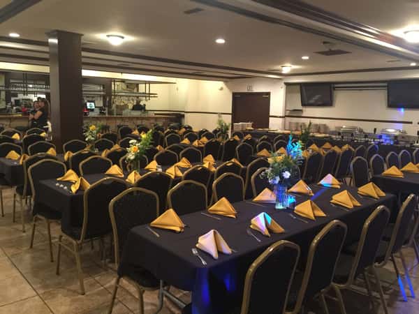 rows of tables with yellow napkins