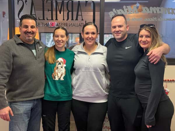 "Group photo of restaurant management team gathered at the corporate office during the Manager Appreciation Breakfast, smiling together and celebrating leadership."