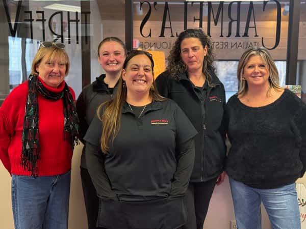 "Group of Mamma Mia's Plymouth Waterfront restaurantmanagers posing for a photo at the corporate Manager Appreciation Breakfast, representing teamwork and company culture."