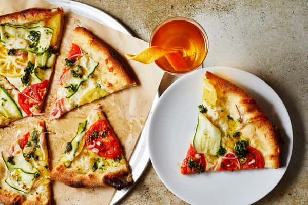 pizza next to glass of wine