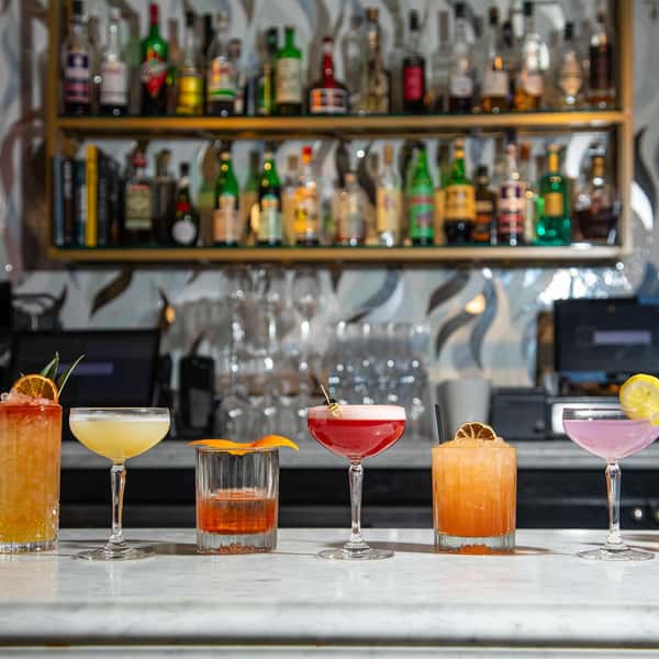 A vibrant lineup of handcrafted cocktails at Sofia NOLA showcases the bar's creativity and elegance—each drink artfully presented against a chic, modern backdrop, inviting guests to sip and savor in true New Orleans style.