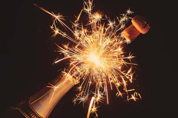 Champagne popping with fireworks coming out