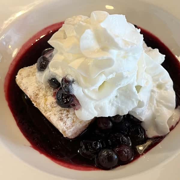 Finger Cake with powdered sugar, blueberry compote & whipped cream