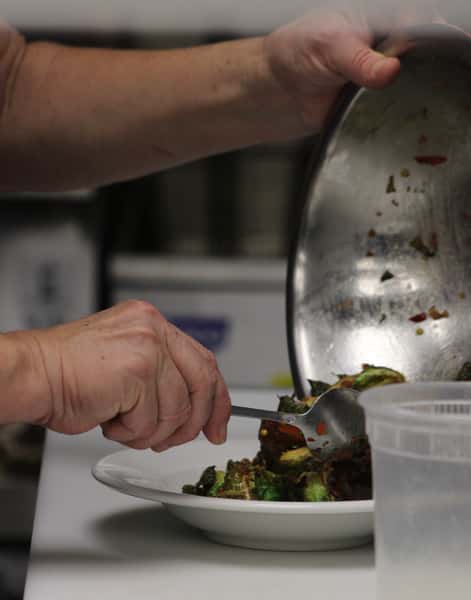 hands with Brussels sprouts