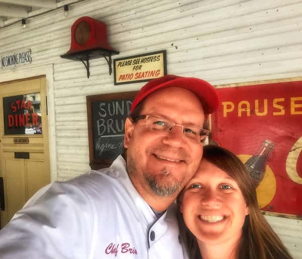 A selfie of Chef Brian and Kate stands in front of "Star Diner." The sign above states, "Please see hostess for patio seating."