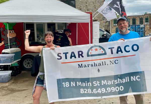 Kate & Brian holding Star Taco Banner in front of Celtic Monkey