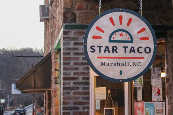 Photo of the Star Taco Sign hanging from the building on Main st.