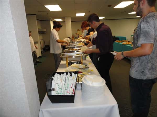 Catering table with people serving themselves