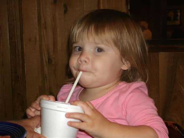 Small child drinking a beverage