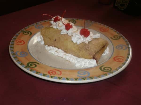 Pastry with whipped cream and cherrys