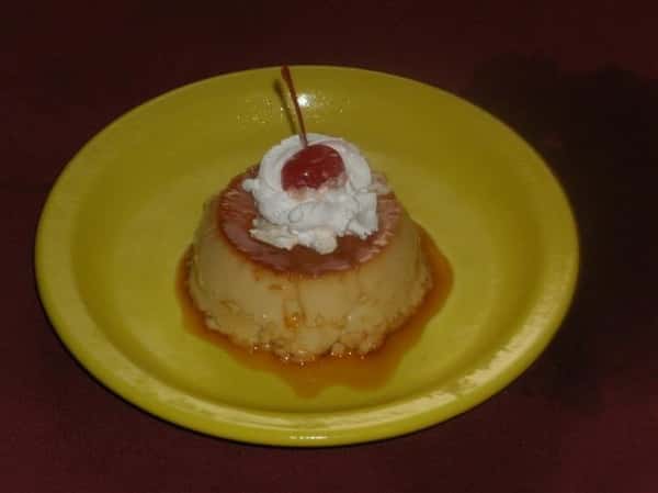 Flan with Whipped cream and a cherry on top