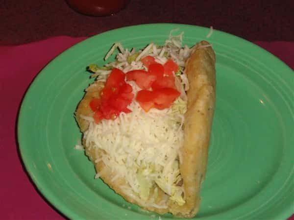 Taco with lettuce, cheese and tomatoes