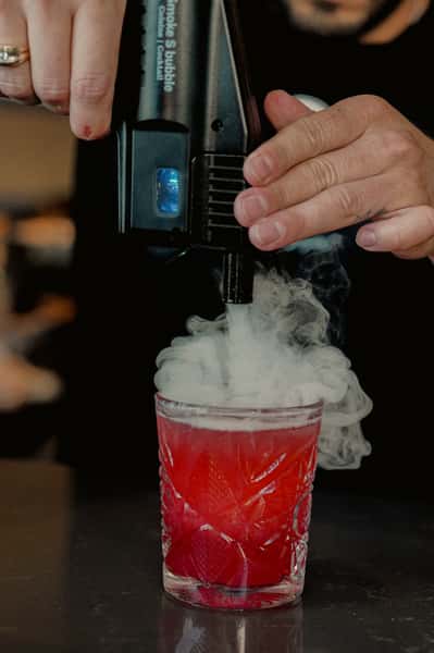 Red drink with ice steam