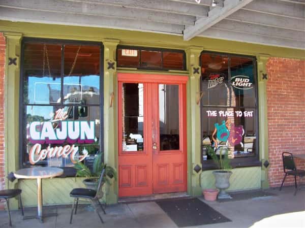 exterior entrance to the cajun corner with chairs and tables setup outside