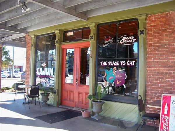 exterior entrance to the cajun corner with chairs and tables setup outside