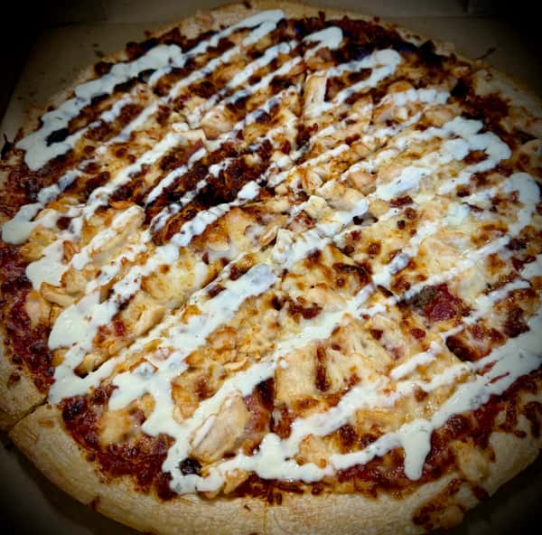 Chicken ranch pizza from Elberta Pizza in Elberta, AL with crispy crust, melted cheese, seasoned chicken, bacon, and creamy ranch drizzle.