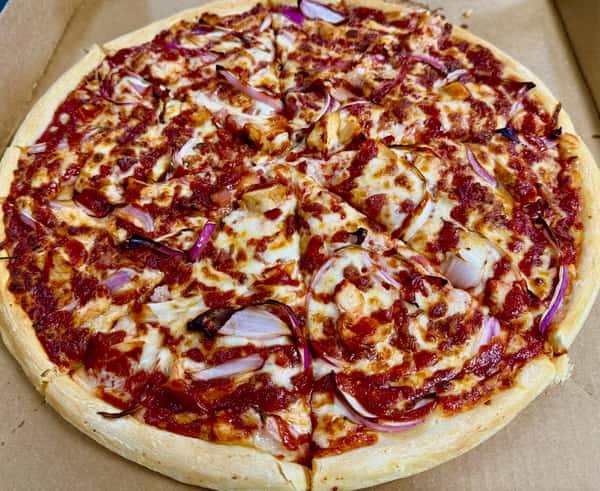 Specialty pizza from Elberta Pizza in Elberta, AL topped with melted mozzarella, red onion, chicken, and rich tomato sauce in a takeout box.