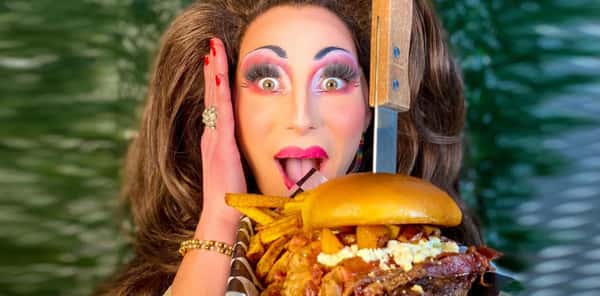 Person holding a large burger