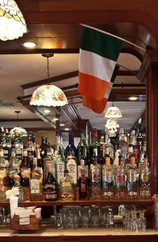 bottles of liquor behind the bar with an irish flag