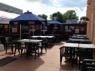 outdoor seating area with four chairs per table and two umbrellas