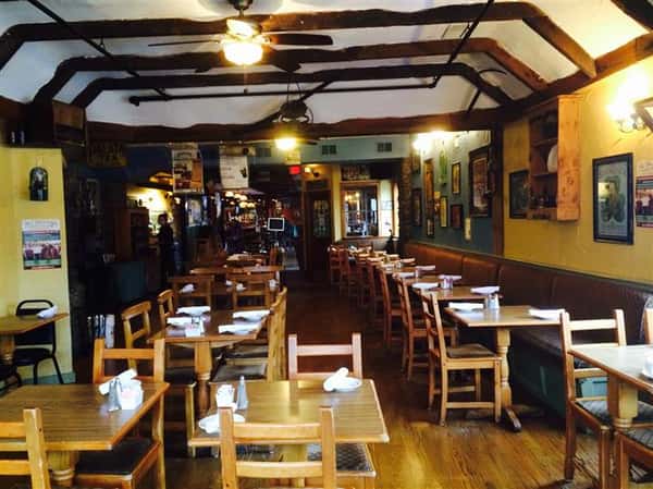 inside seating area with two chairs per table with half of the tables with a booth on one side and a chair on the other side of the table