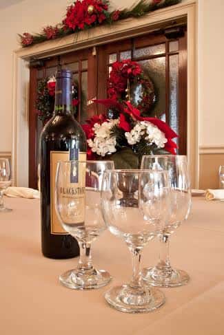 three wine glasses with a wine bottle