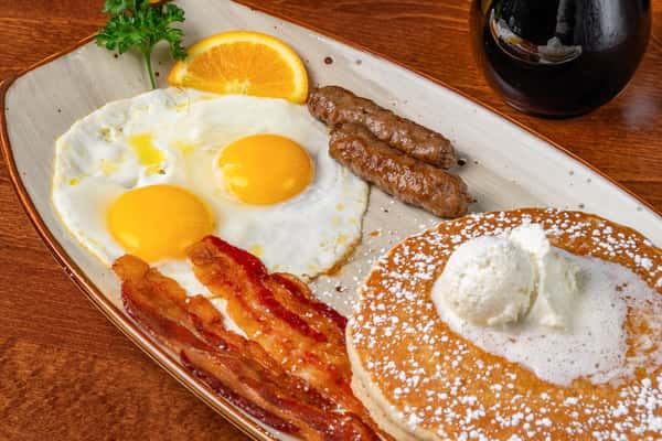 bacon and eggs with sausage and pancakes
