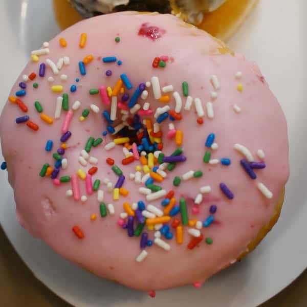 A pink sprinkled donut