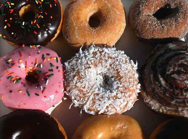 A collection of a bunch of different types of donuts.