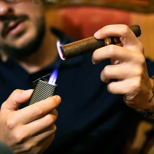 Gentleman lighting a cigar