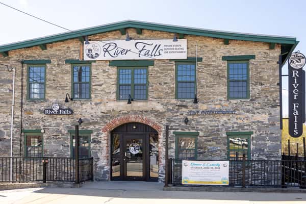 rustic stone restaurant exterior with signage and outdoor entrance in a historic building