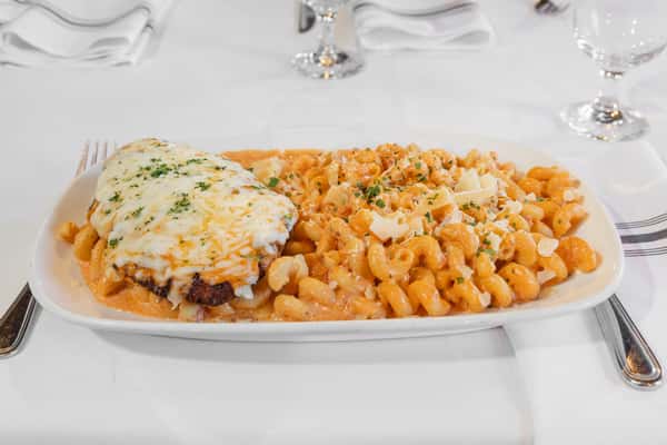 chicken parmesan plated with creamy macaroni and cheese in a hearty comfort food presentation