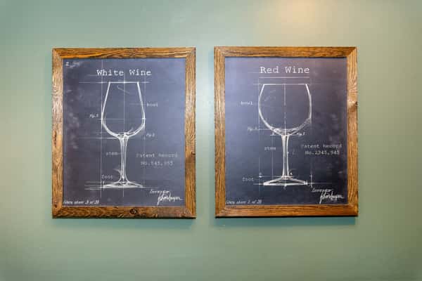 decorative wine-themed wall art displayed in a rustic restaurant interior