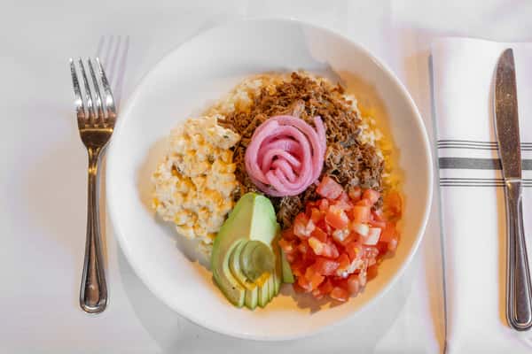 barbacoa rice bowl topped with avocado, pickled onions, and fresh pico de gallo